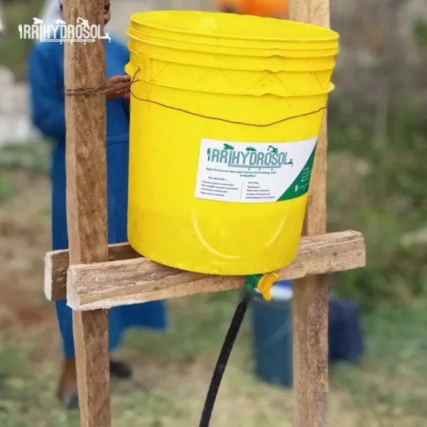 Close-up of mounted bucket connected to two drip lines at KIOF demonstration farm