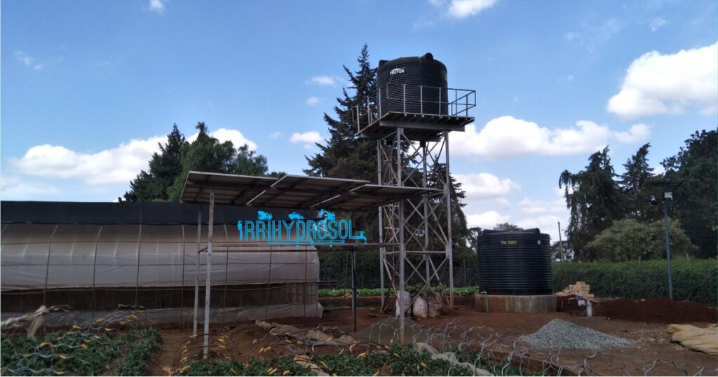 A complete water solution setup featuring a solar-powered borehole, elevated steel water tower, and drip irrigation system ready for farm use